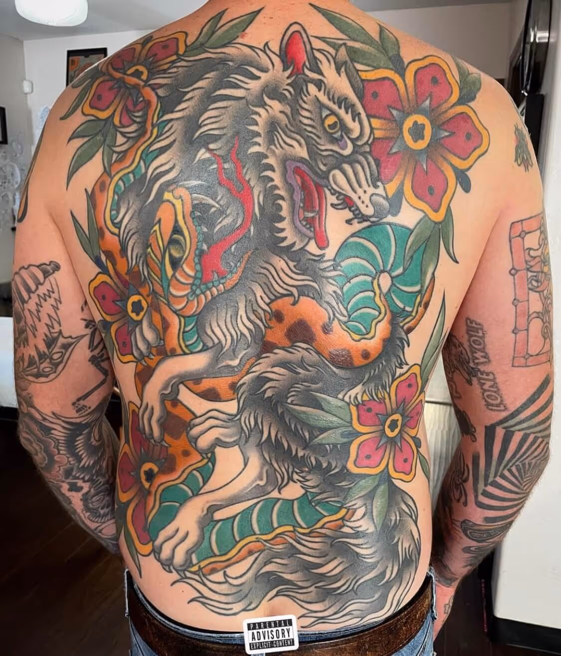 Traditional wolf and snake fighting back tattoo by Brittany Quintero of Sweet Heart Tattoo.