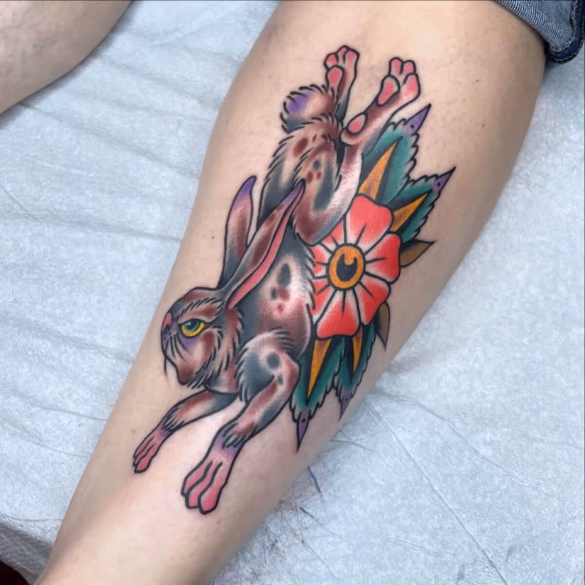 Traditional rabbit with flower tattooed by Joshua Bighaus.