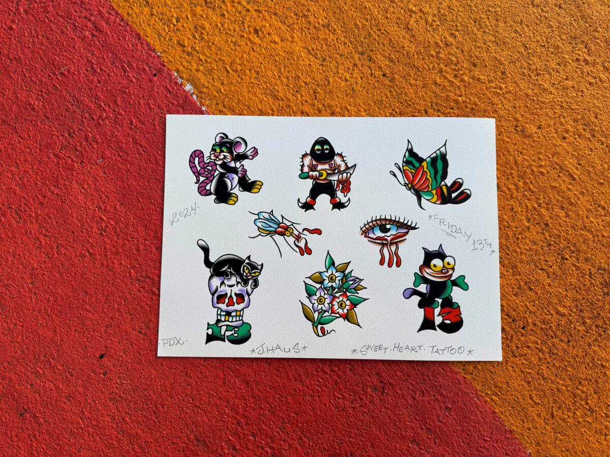 Tattoo flash sheet with colorful classic tattoo designs including a cat, skull with a cat, flying butterfly, eye with tears, flower bouquet, and a dagger-wielding figure.