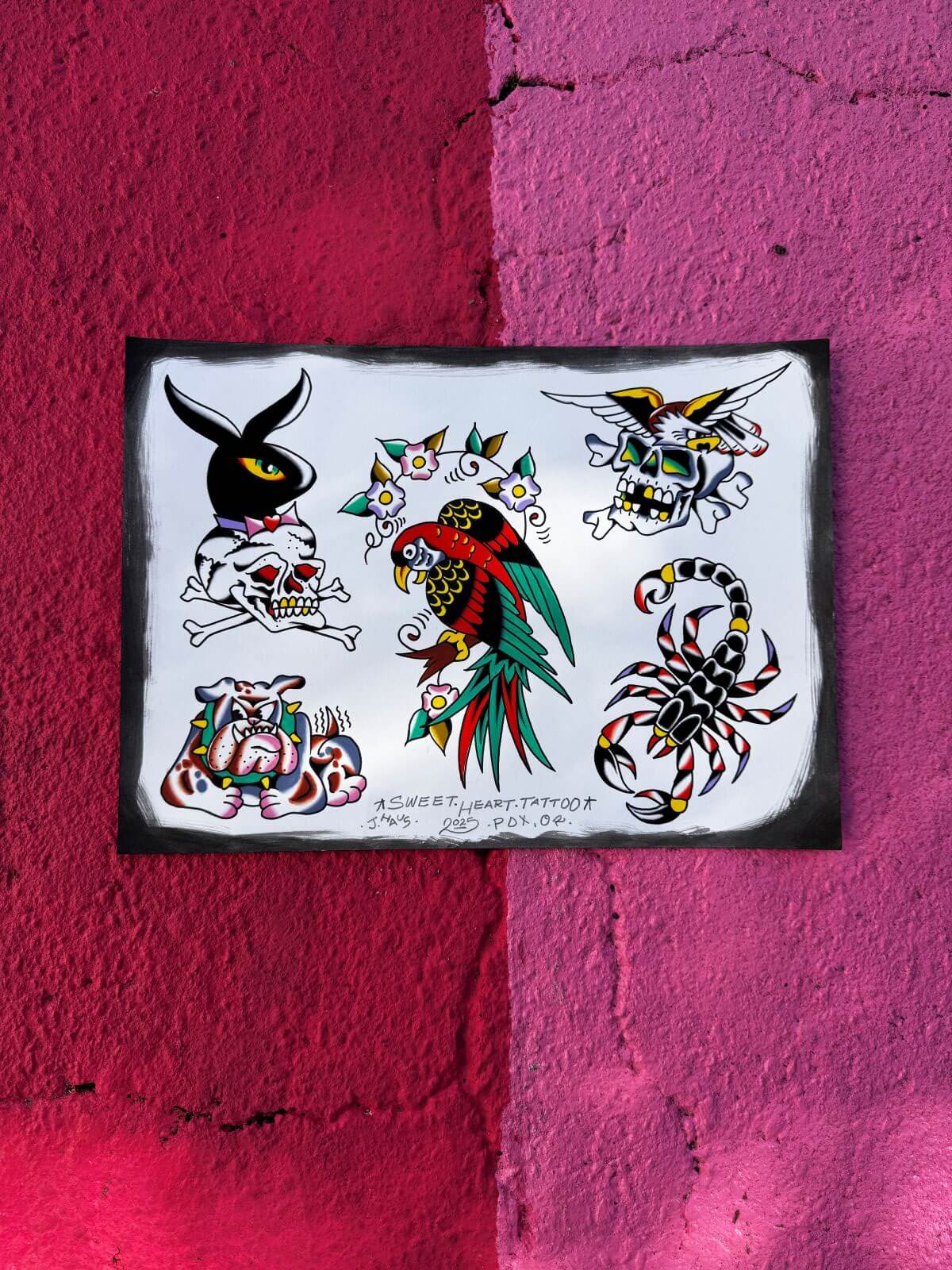 Sheet of traditional-style tattoo flash art featuring a black rabbit with a skull, colorful parrot with flowers, winged skull, angry bulldog, and a black, red, and yellow scorpion on a white background.