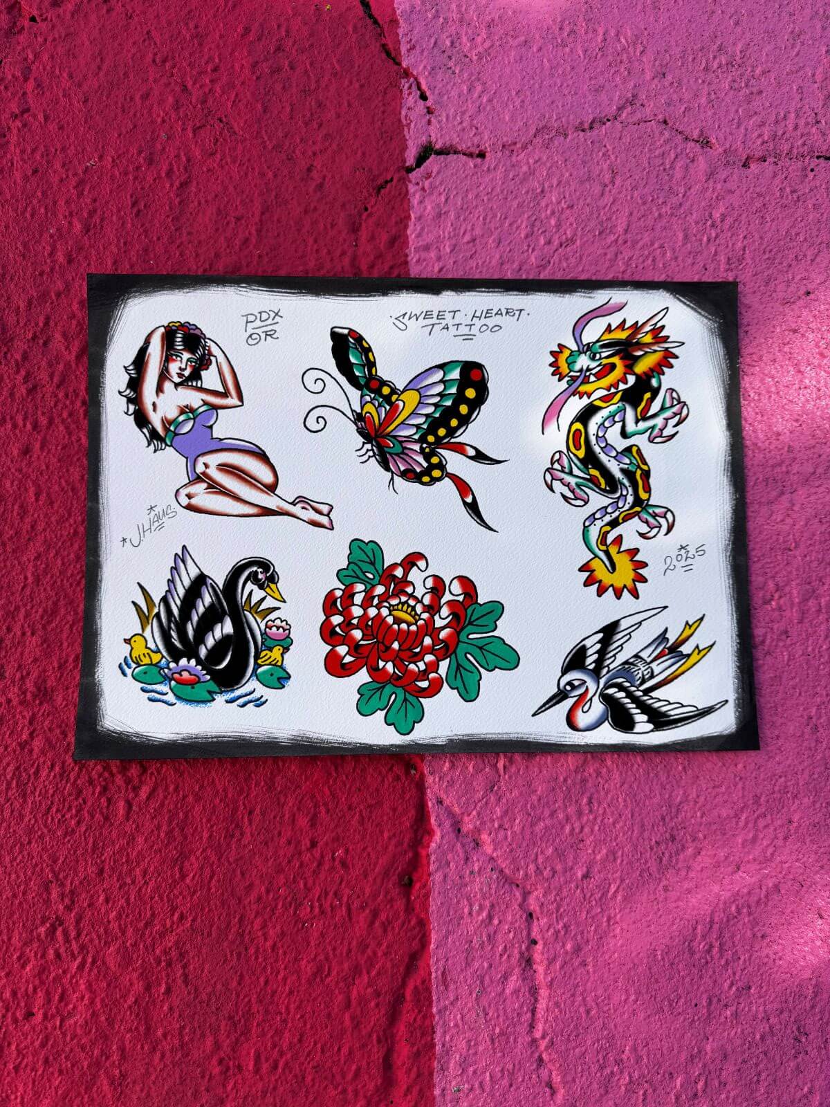 Tattoo flash sheet with traditional designs including a pin-up girl, butterfly, dragon, black swan, red chrysanthemum, and bird on white background.