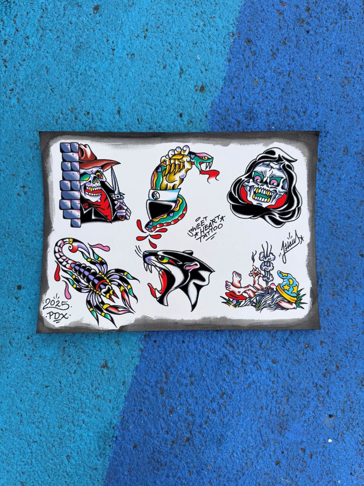 Tattoo flash sheet featuring colorful traditional designs including a skeleton with a knife behind bricks, a snake held by a hand, a grim reaper skull, a scorpion, a roaring panther, and a chained wizard lying on the ground.