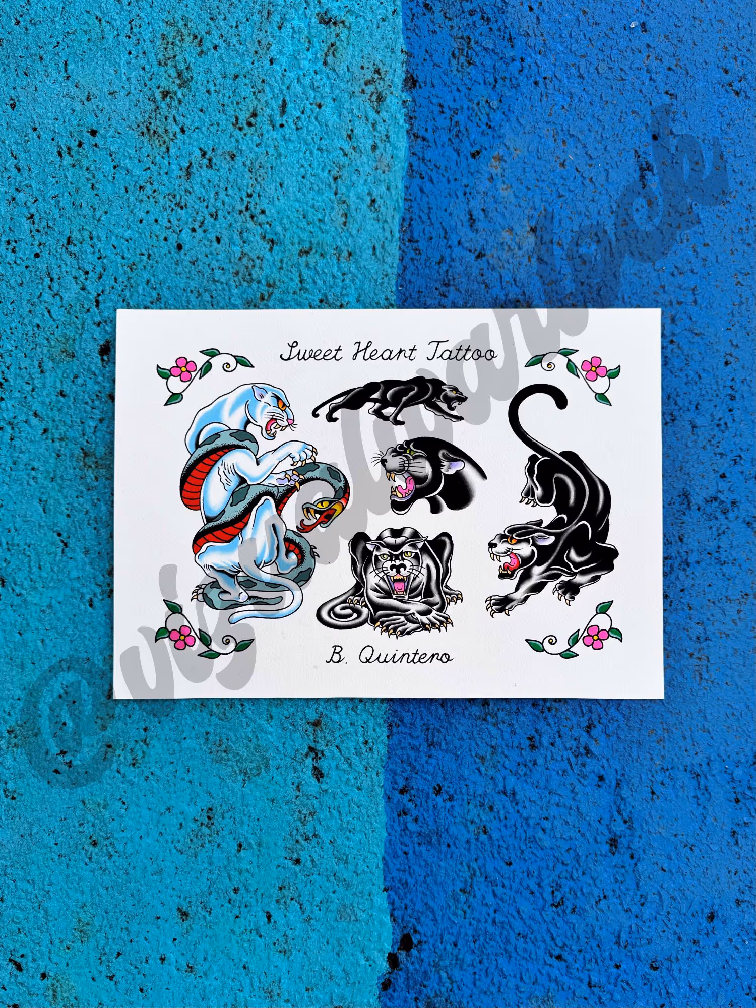 Tattoo flash sheet with five panther designs and a coiled snake on a white background with floral corners.