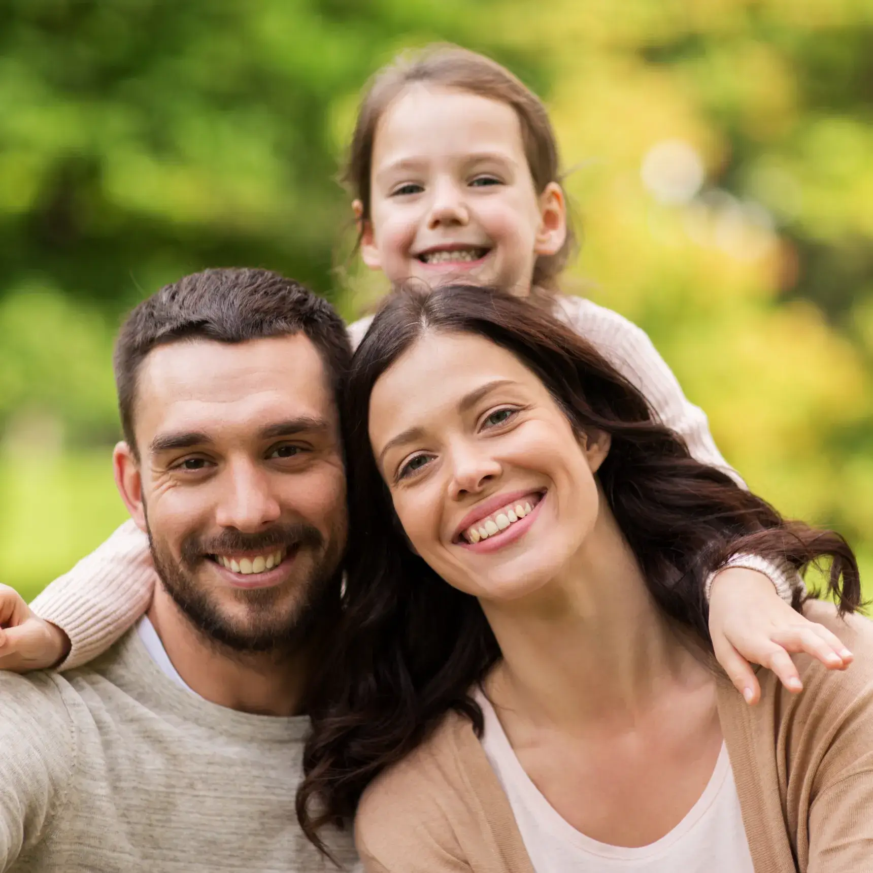 a man, woman and child are posing for a picture