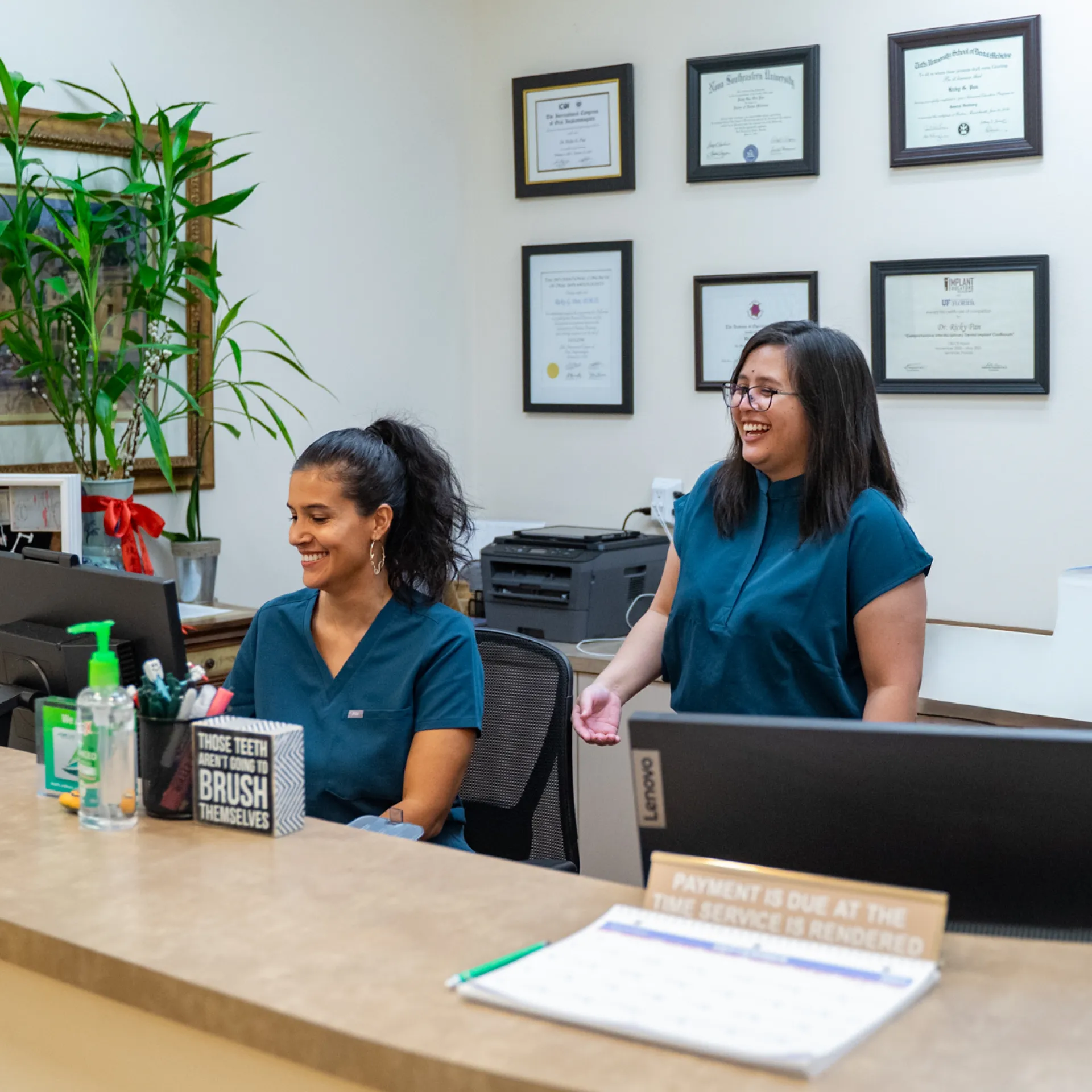 Pine Avenue Smiles team members at the front desk. 