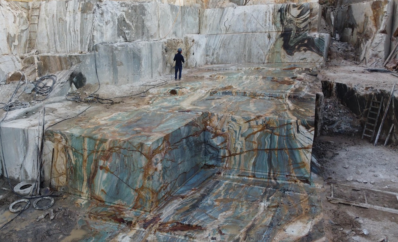 A person standing in a stone quarryAI-generated content may be incorrect.