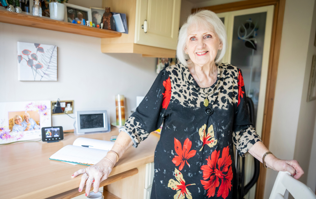 An elderly woman in her kitchen
