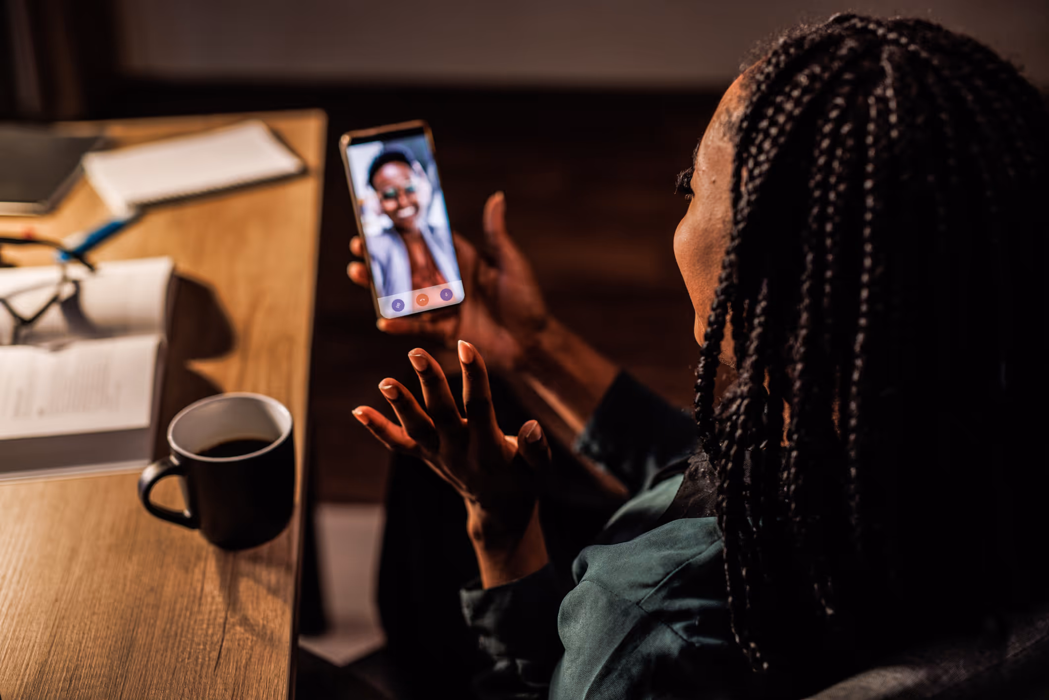 A person holding a phone while on a video call
