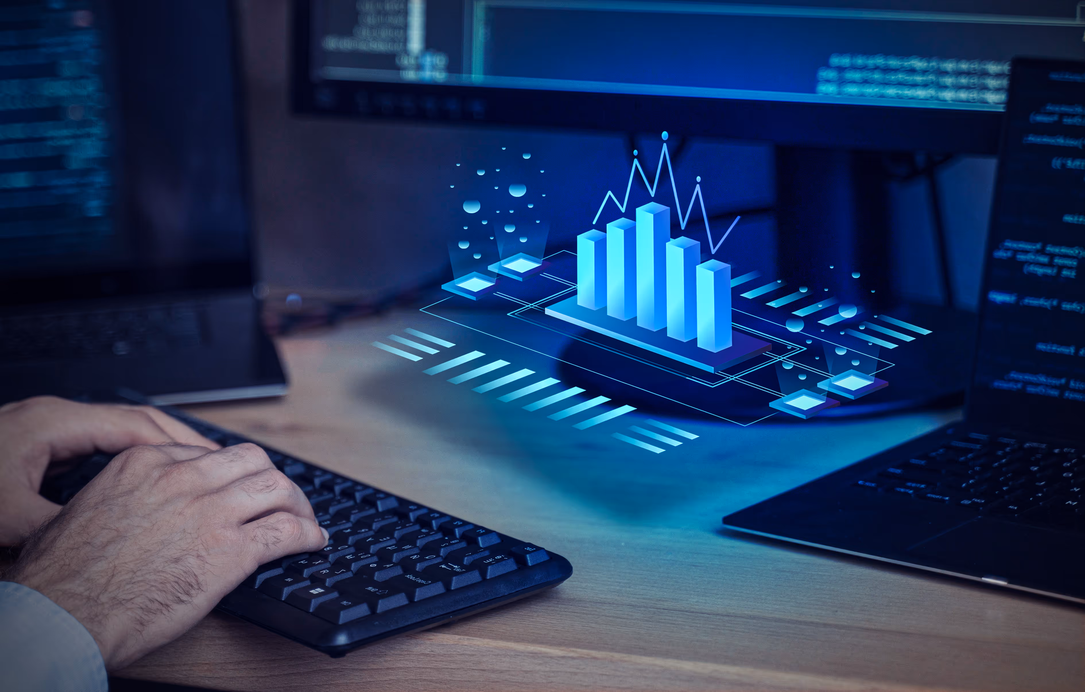 An image of a man's hand typing on a keyboard with a hologram of a blue data bar chart in front of him.