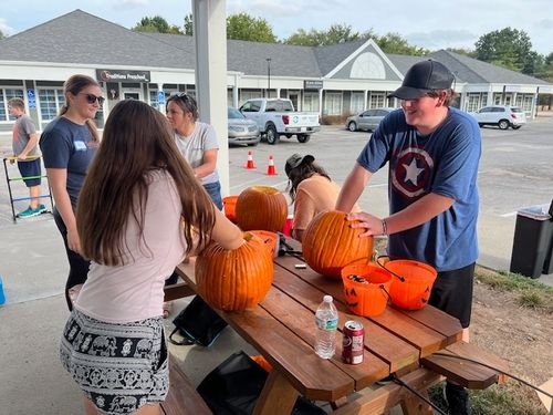 Kids carving pumpkins at the Fall Festival at Pro Deo