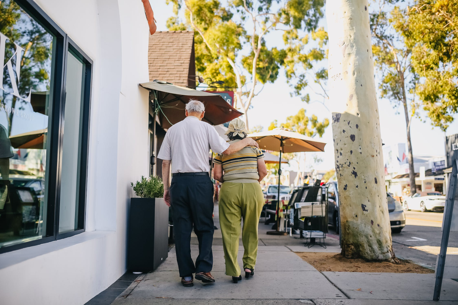 a person and person walking down a sidewalk