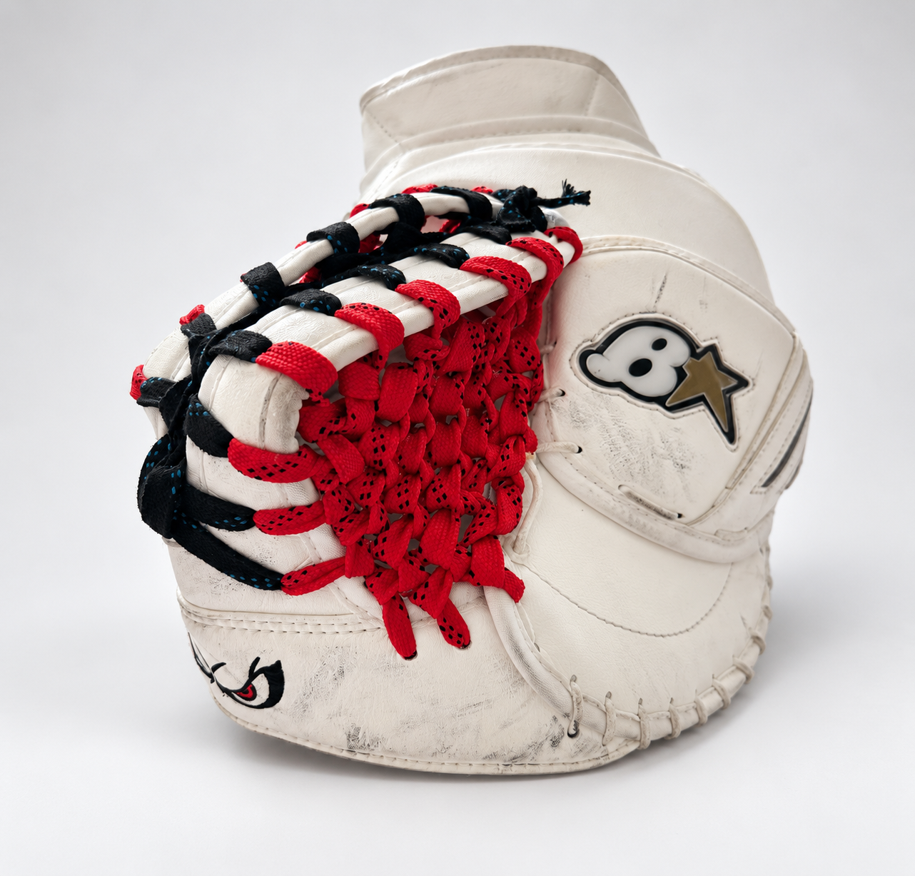 Goalie glove with red and black custom stitching by Hockey Detox Co.