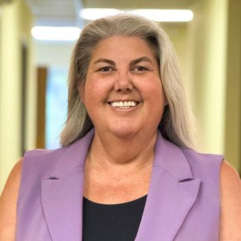 Headshot of Megan Jones in front of a hallway.