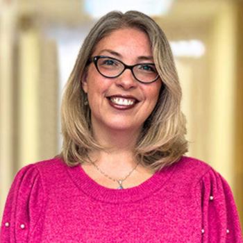 Headshot of Christina Garris in front of a hallway.