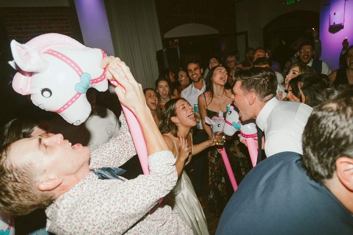Wedding guests dancing at Denver reception with DJ lighting