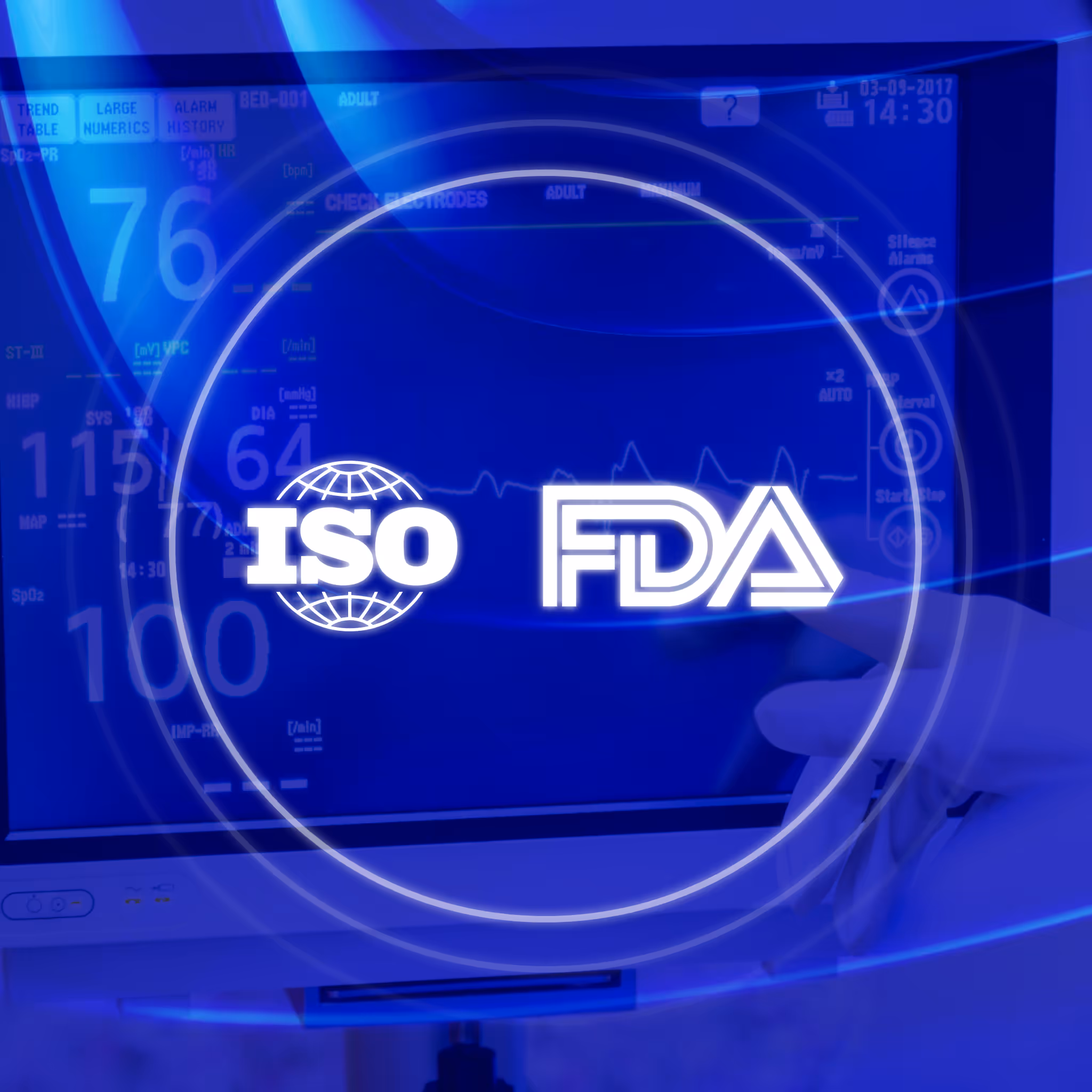 Medical monitor with blue screen displaying vital signs, ISO globe logo, and FDA approval, with a gloved hand interacting with the device.
