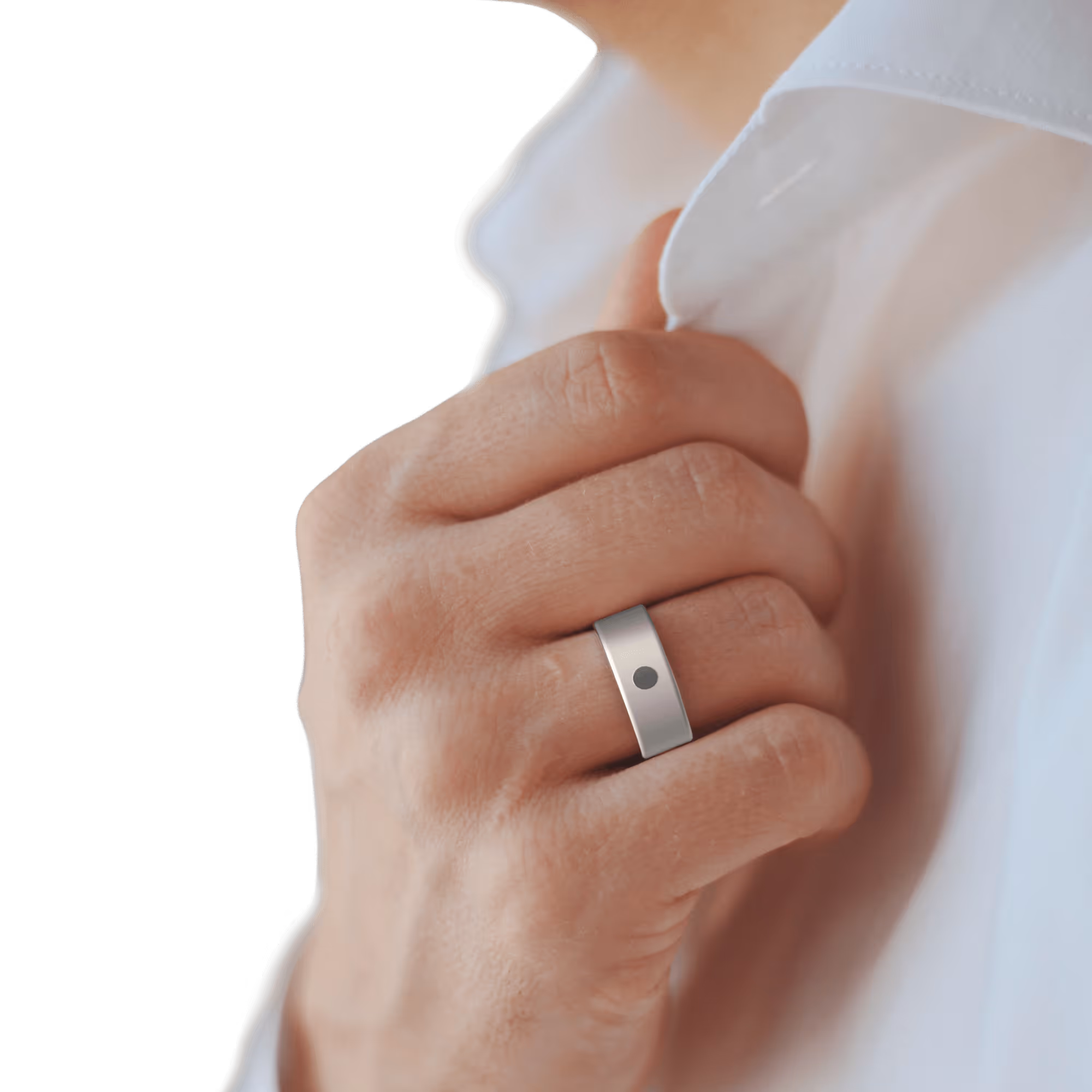 Close-up of a hand adjusting a white shirt collar, wearing a silver ring with a black dot on the ring finger.