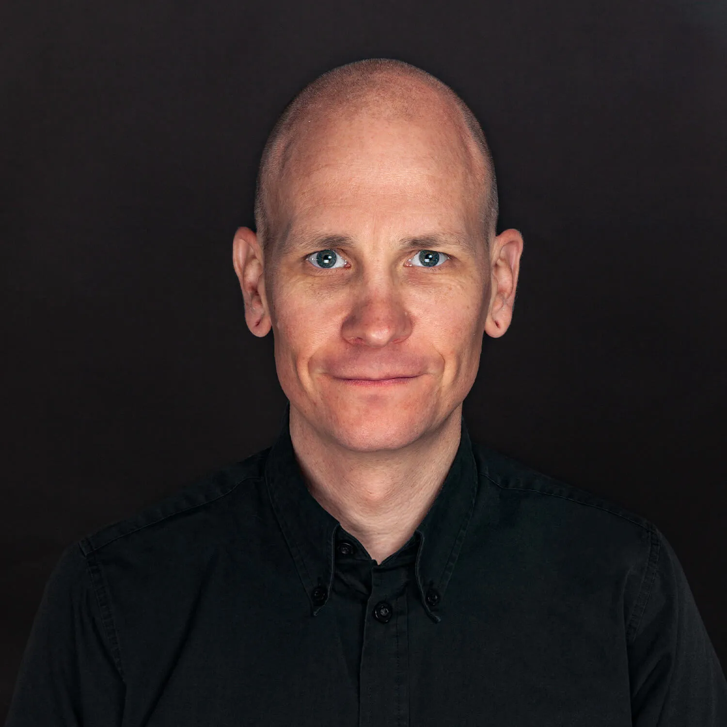 team member's portrait on dark background