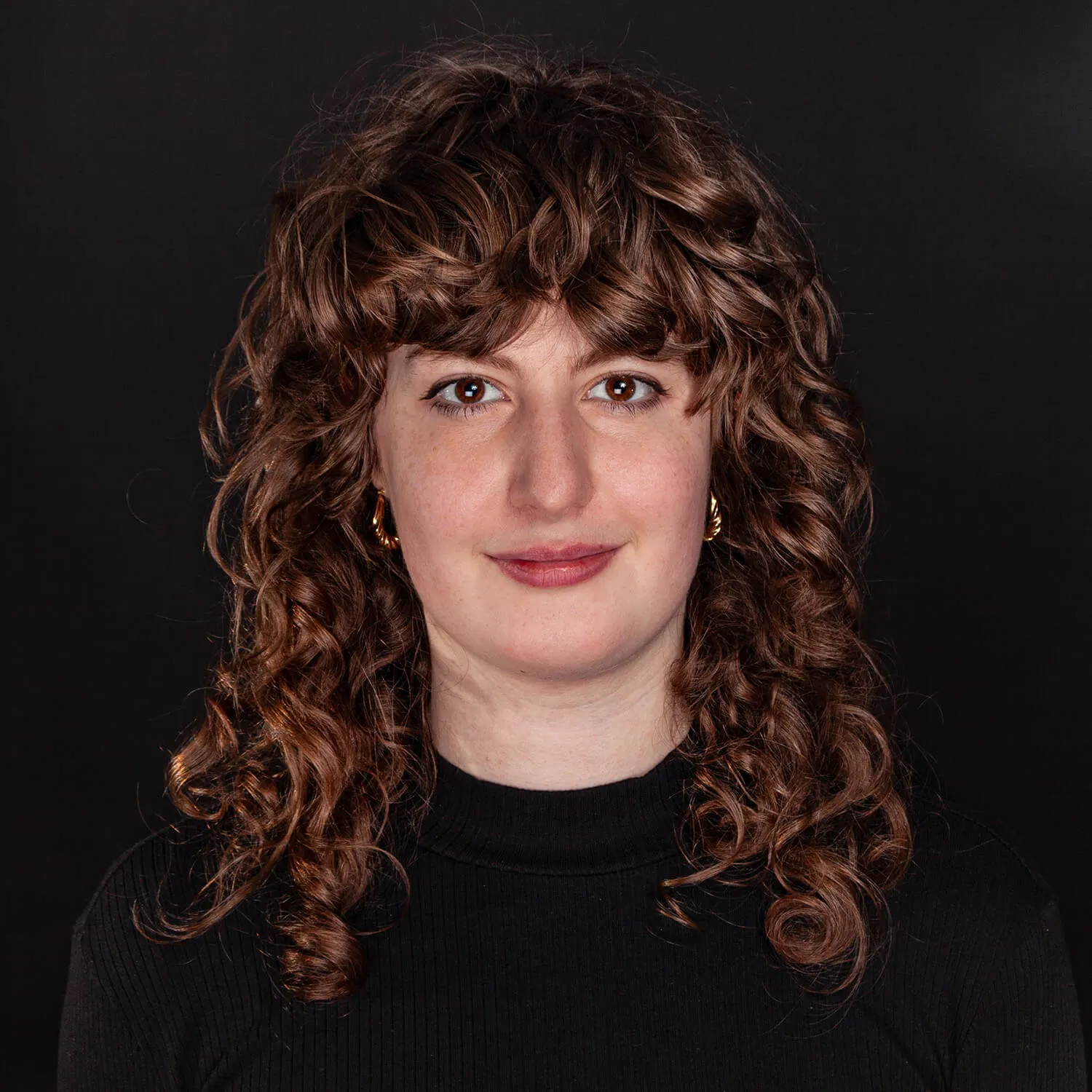 team member's portrait on dark background