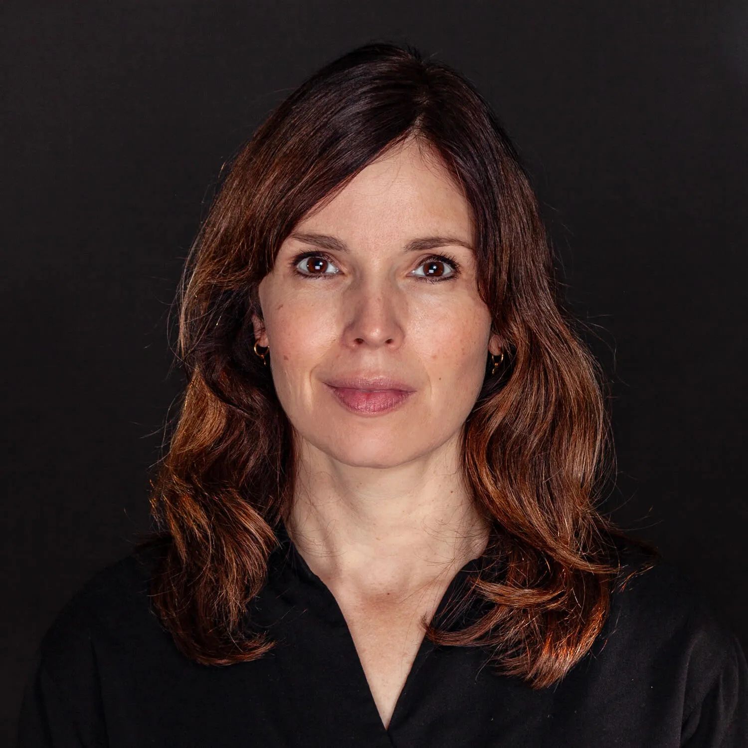 team member's portrait on dark background