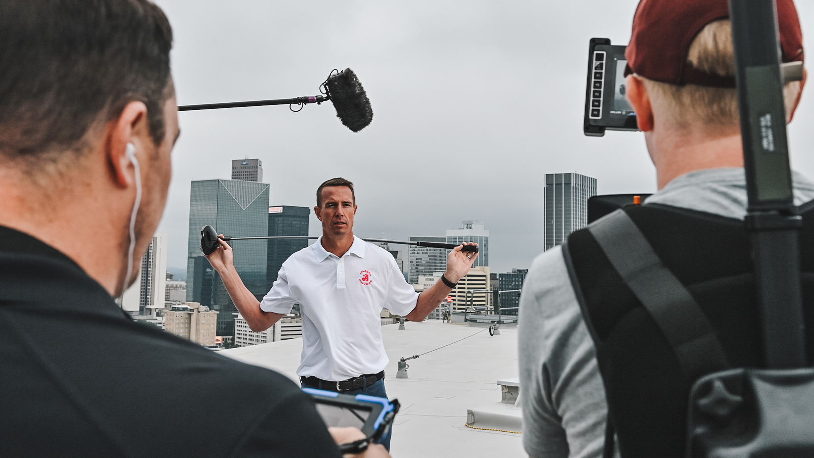 Atlanta Drive Golf Club brand identity system for the TGL team: golfer holding a club while being filmed by a production crew.
