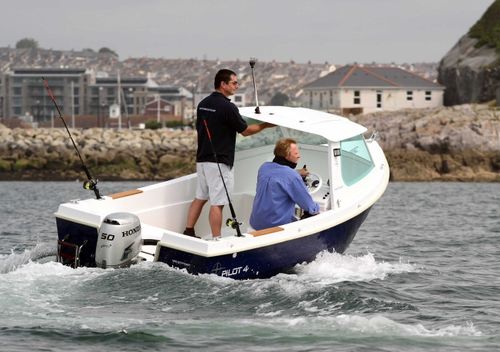 "Pilot 4" motor boat on the water with 2 male adults inside