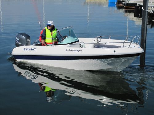"EMILI 460" sports motor boat steered by male adult on the water