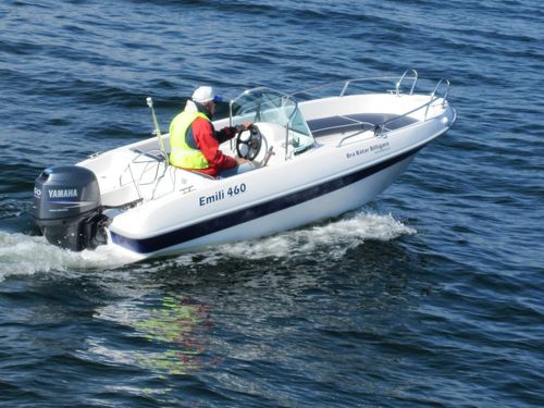 "EMILI 460" sports motor boat steered by male adult on the water