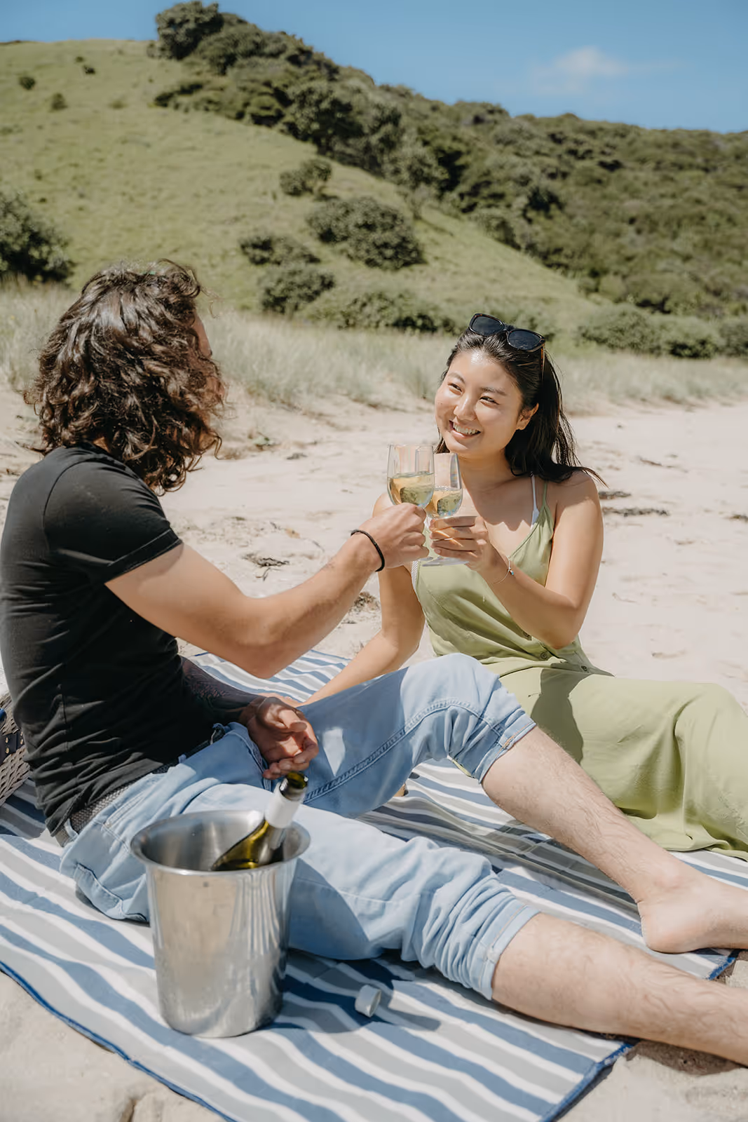 Couple picnic ashore, Waewaetorea Bay of Islands, New Zealand