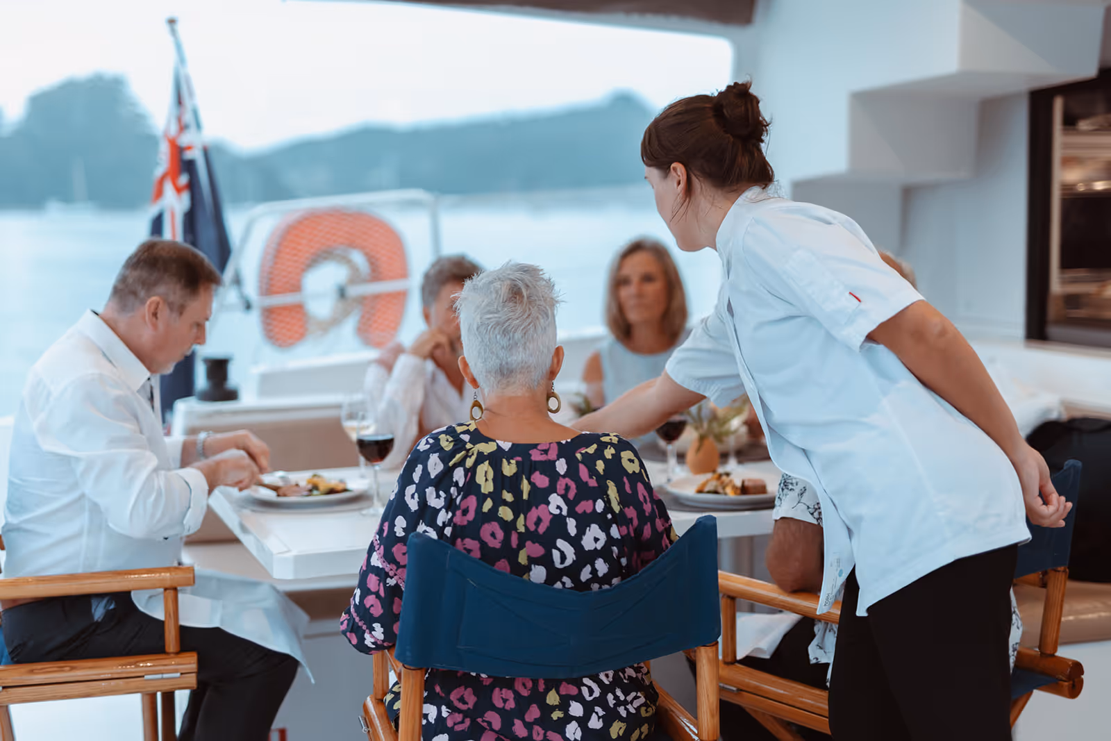 Chef serviving guests in cockpit of Serenity