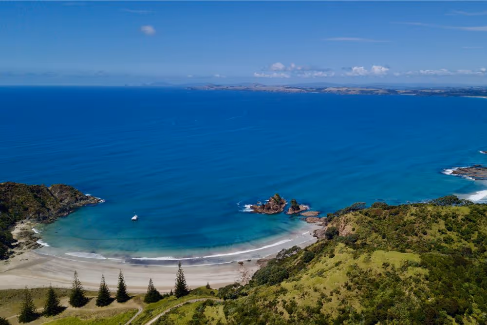 Serenity anchored beneath Kauri Cliffs