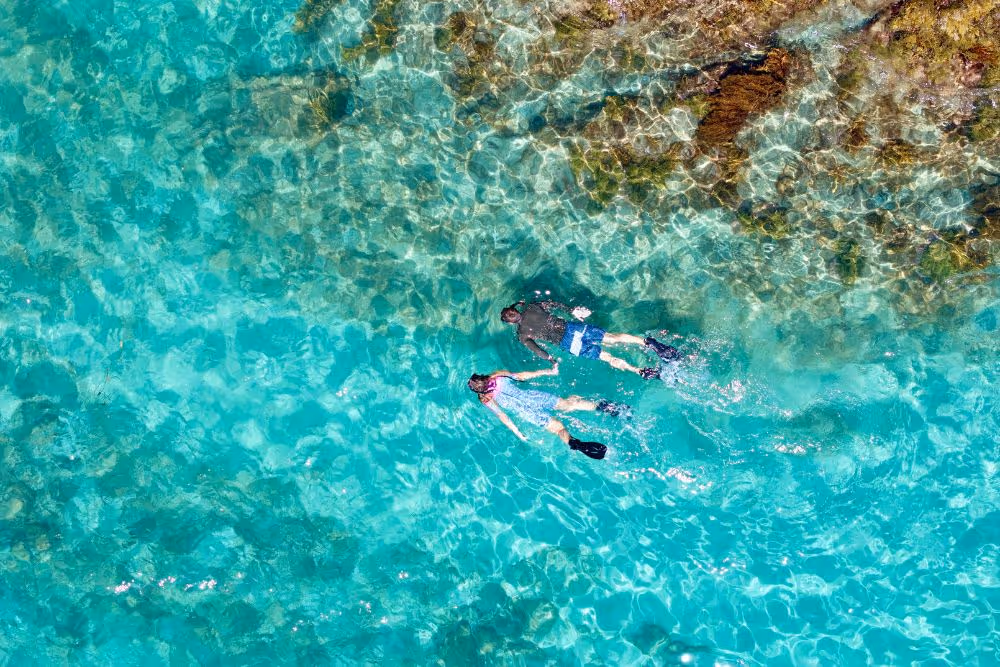 Couple snorkel along shoreline