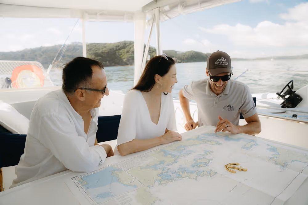 Guests and Captain at chart in the cockpit