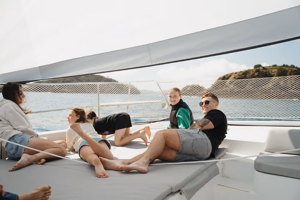 Family relaxing on the foredeck of Serenity