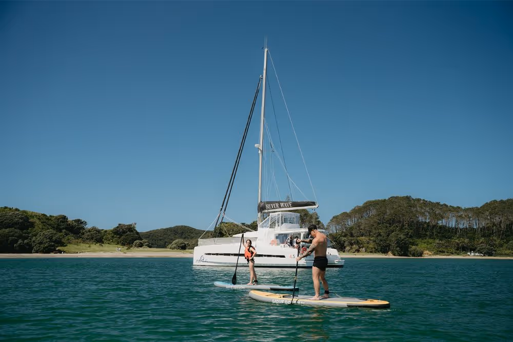 Stand-up paddleboarding with Serenity in the background