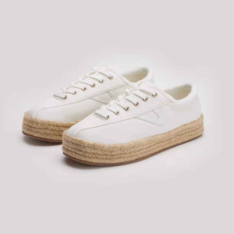 Pair of white canvas sneakers with thick jute rope soles on a light background.