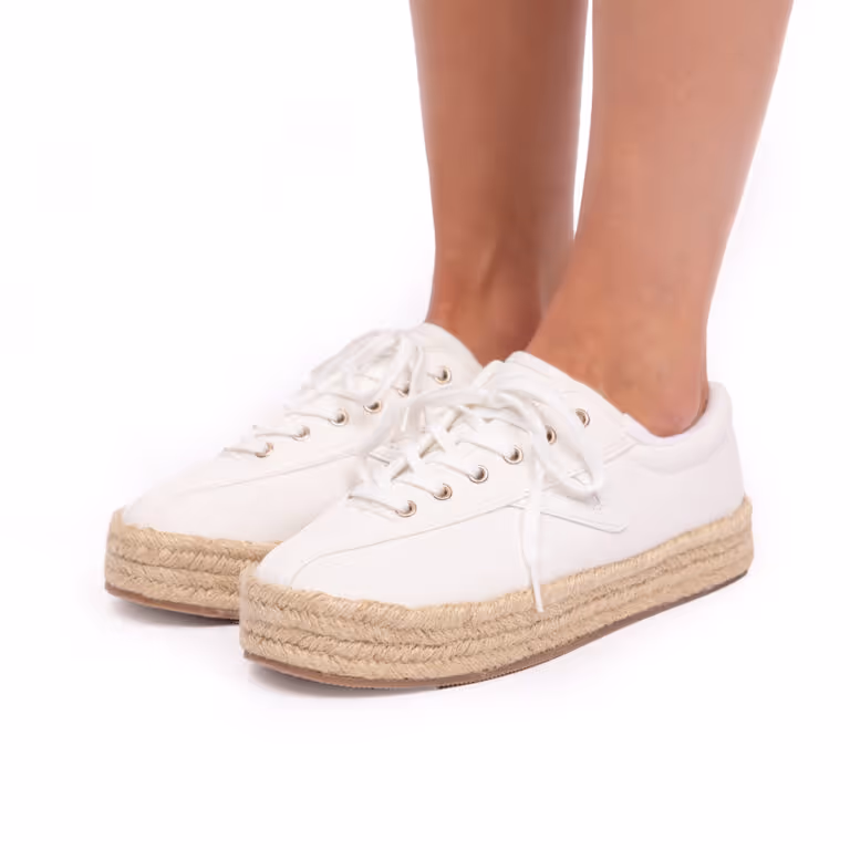 Pair of white sneakers with rope-wrapped platform soles worn on bare feet.