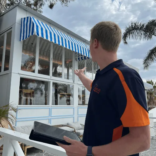 Dazzler team member pointing to building