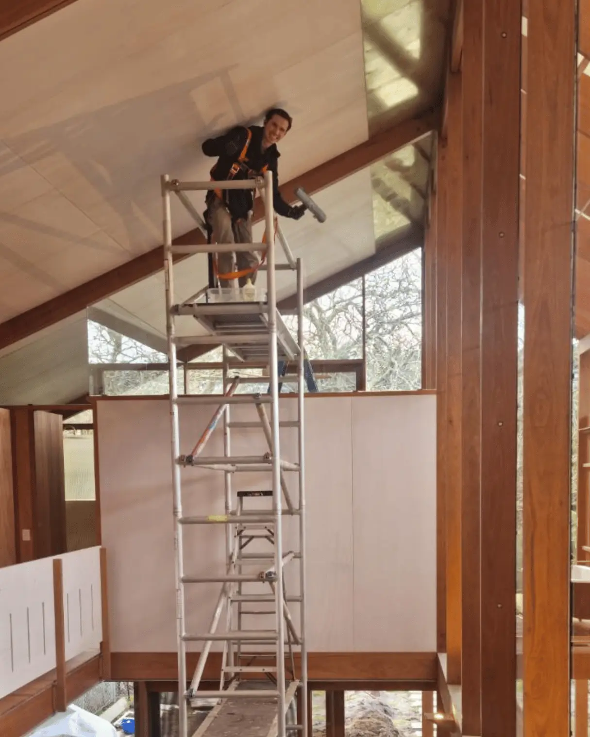 Dazzler team member on scaffolding cleaning high windows