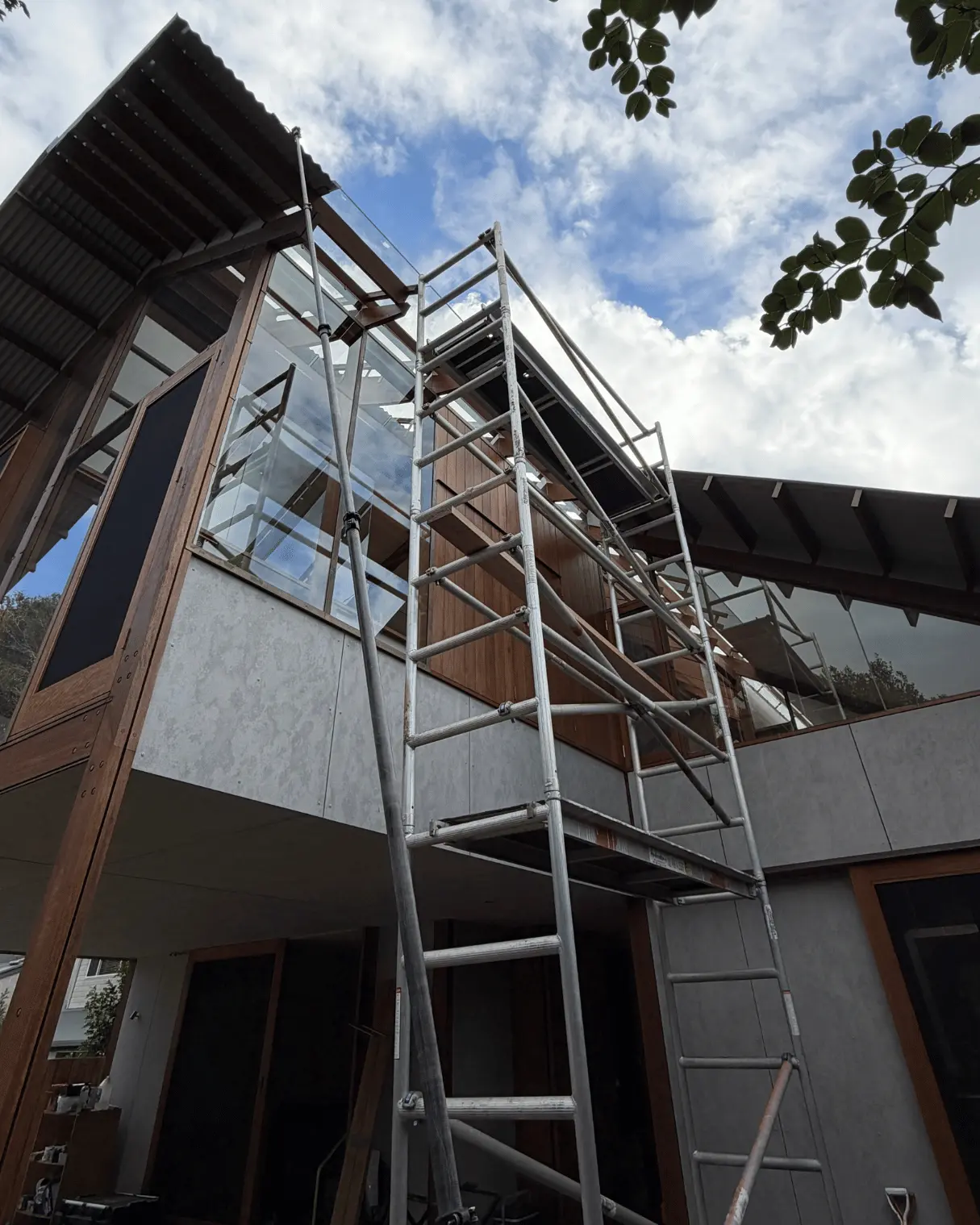 Scaffolding set up to clean high glass on a modern home