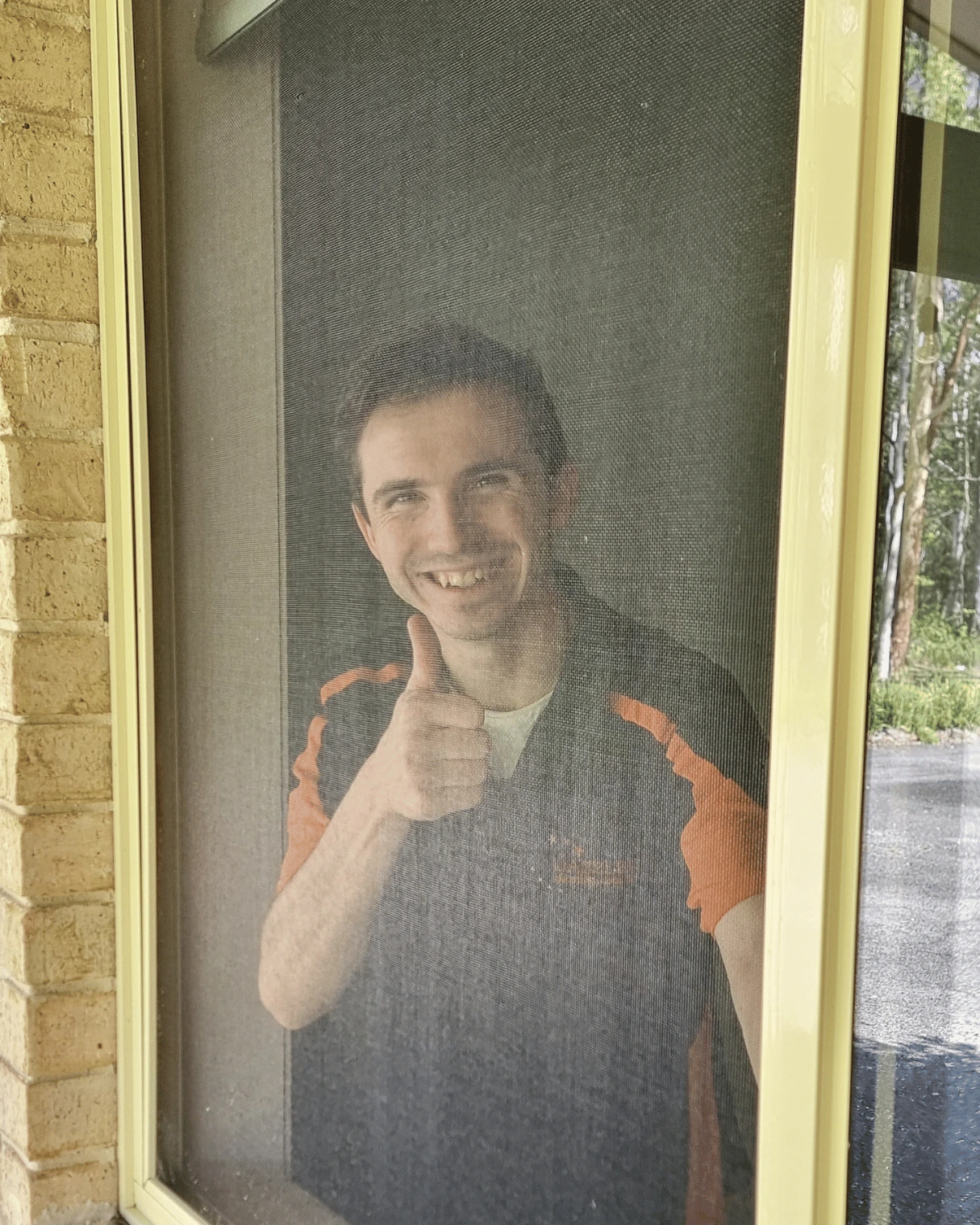 Dazzler team member behind a freshly cleaned flyscreen