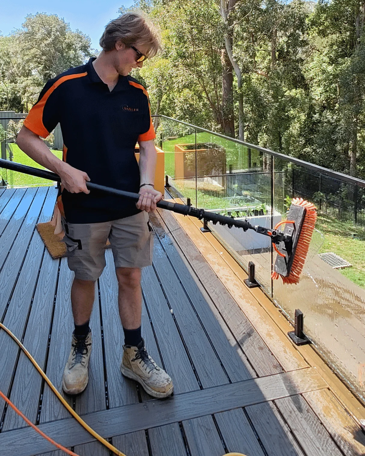 Dazzler team member cleaning glass balustrades