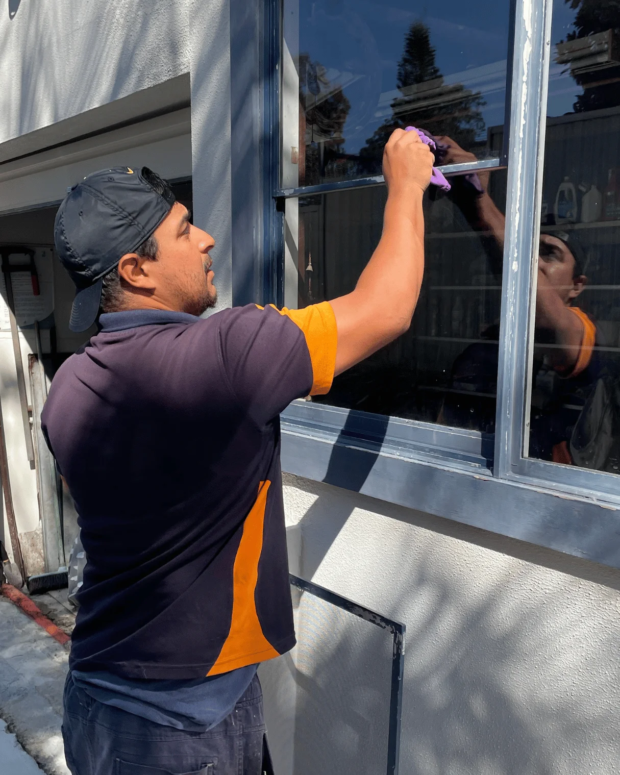 Dazzler team member hand-detailing a window