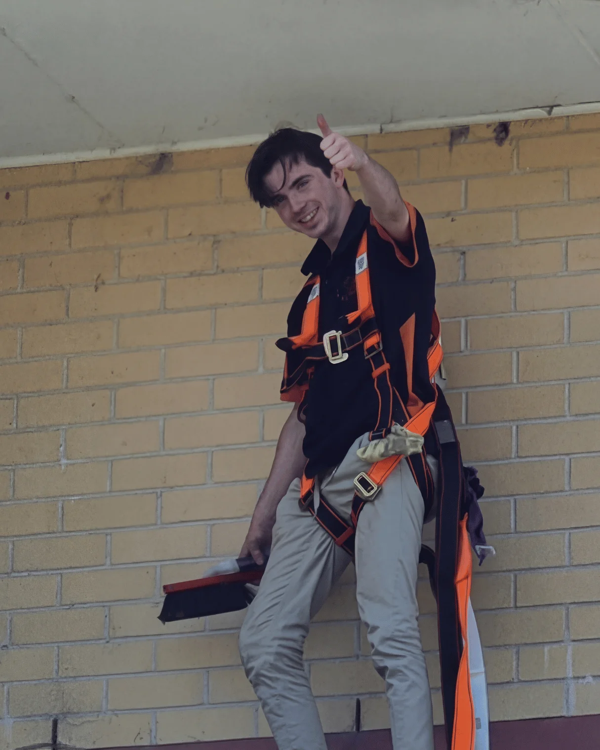 Dazzler team member in a roof safety harness