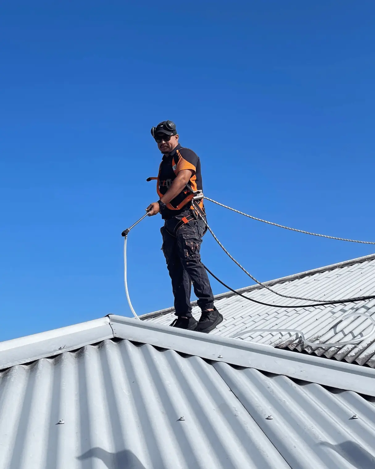Dazzler team member soft washing a Colorbond roof
