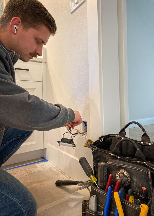 electrician changing out a plug