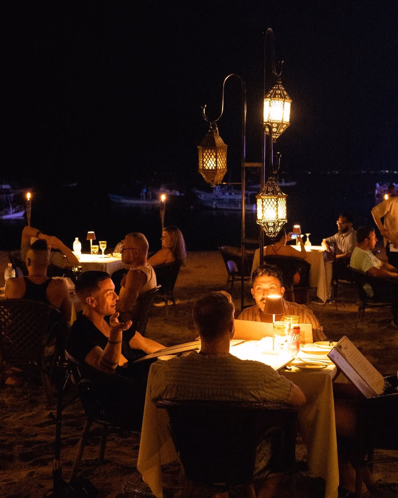 Candlelit tables on the sand at La Palapa at night