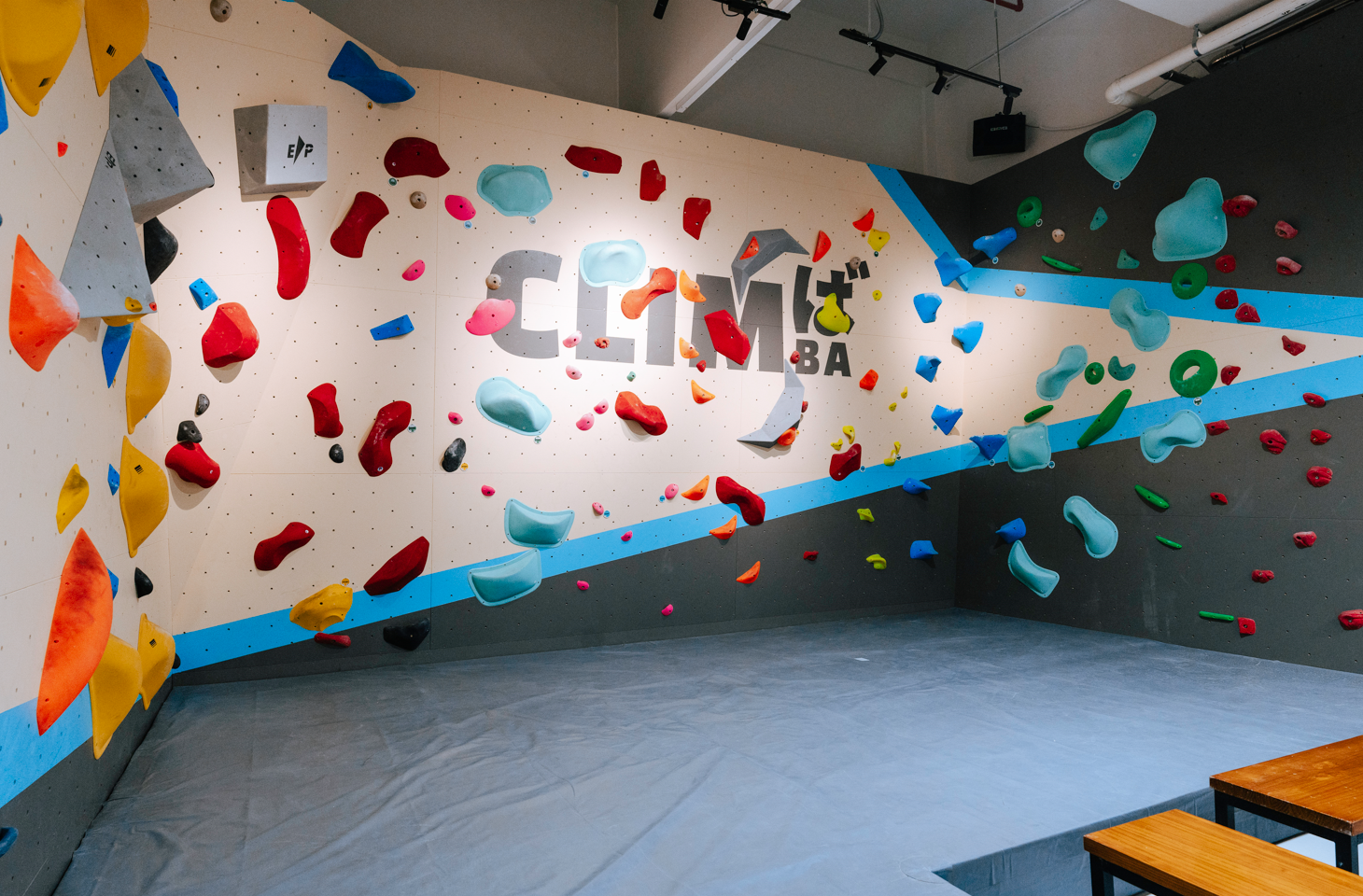 Climber reaching for a hold on Climba's bouldering wall