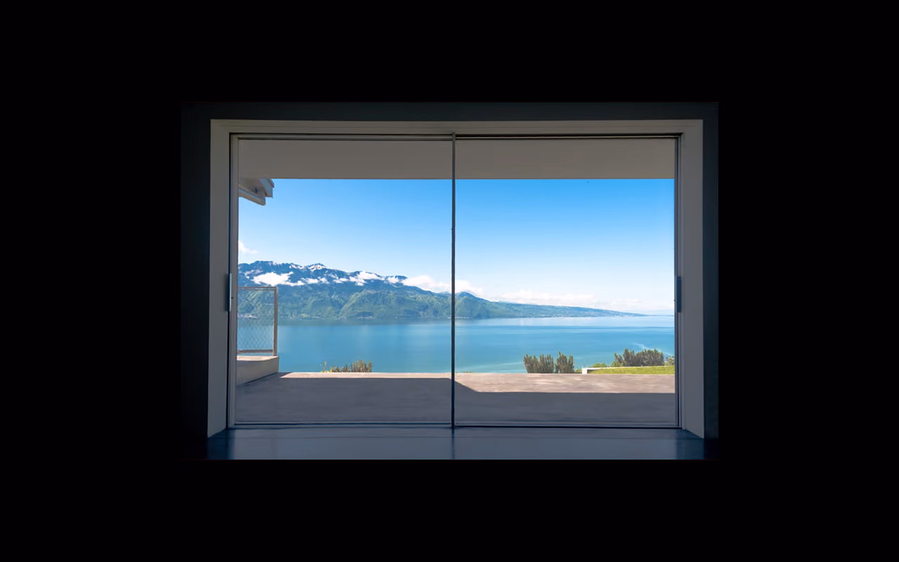 View from a minimalist bay window on a lake and mountains