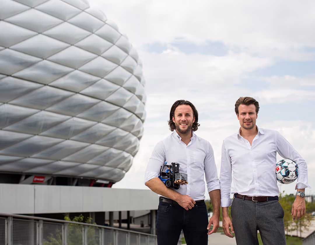 The two Kinexon founders in front of the Allianz Arena Munich.